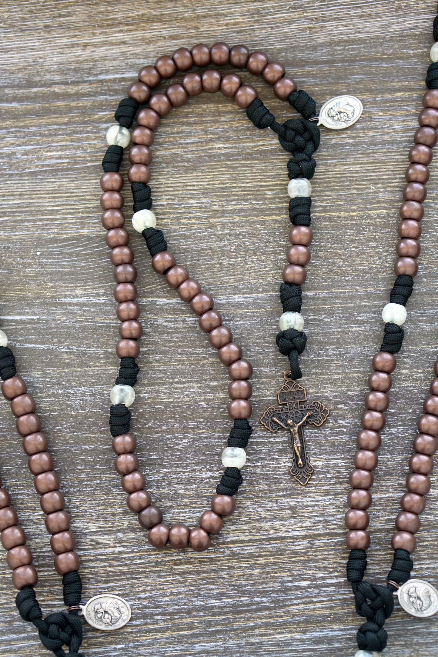St. Anthony Heretic Hammer 5 Decade Paracord Rosary - Stylish and durable rosary featuring black paracord, copper and pearl beads, a devotional medal, and Pardon Crucifix for daily prayers against heresy.