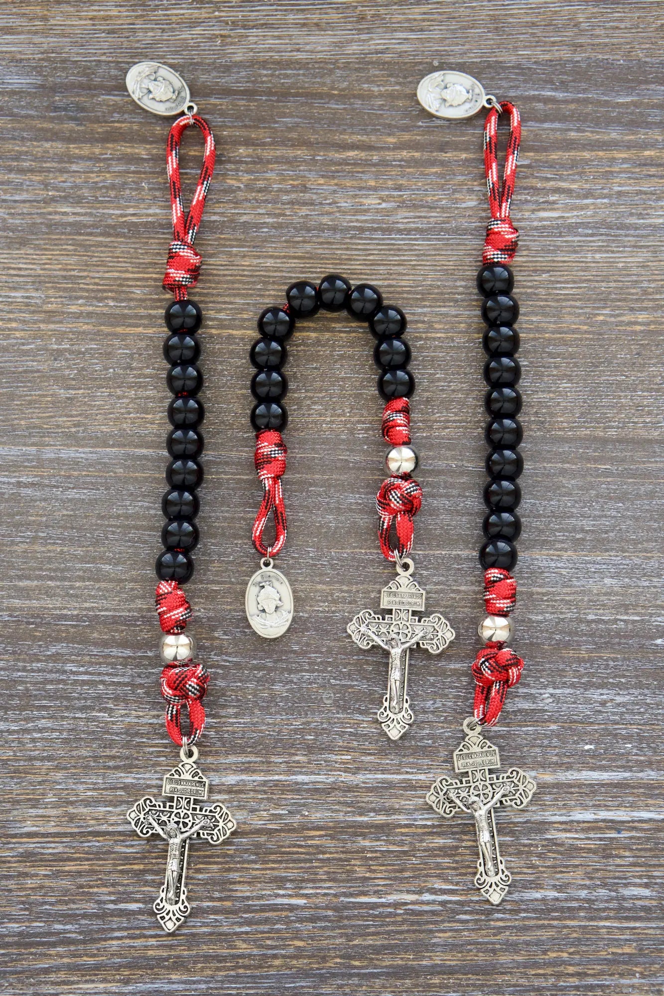 Symbolic firefighter gift: Silver St. Florian medal rosary crafted from strong paracord, representing resilience and faith.