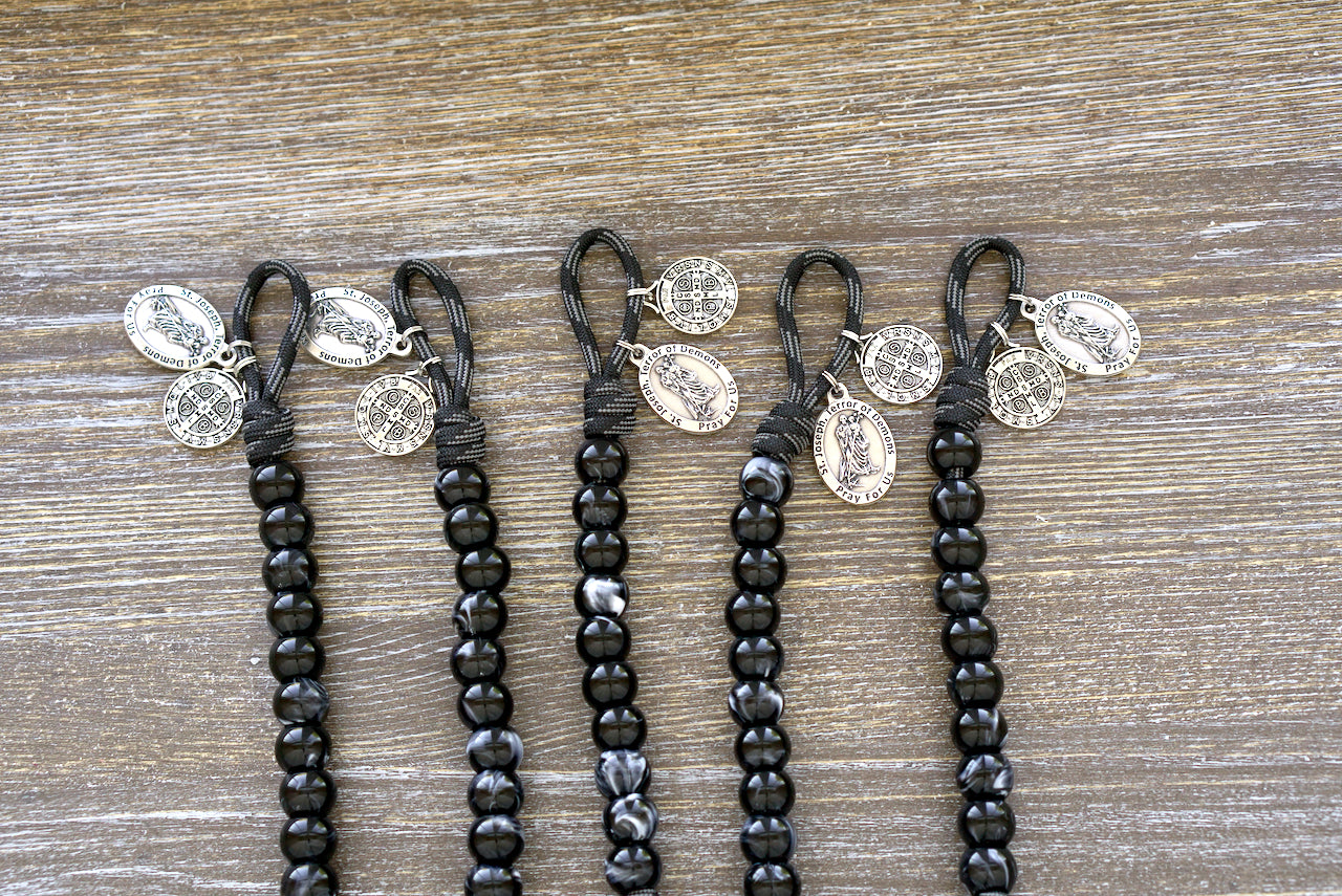 Terror of Demons - St. Joseph - Pocket Paracord Rosary featuring black/white Hail Mary beads, red/maroon Our Father bead, St. Joseph and St. Benedict medals, and a 2-inch pardon crucifix; made with paracord 550 and 12mm acrylic beads.