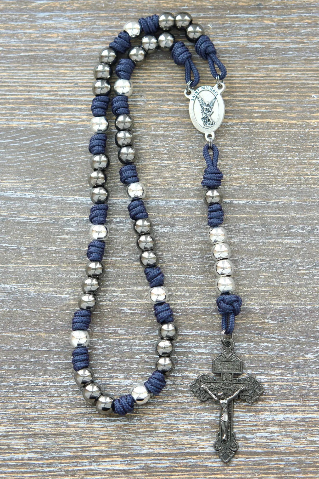Navy blue St. Michael paracord chaplet with 10mm metal alloy beads and a silver St. Michael medal centerpiece.
