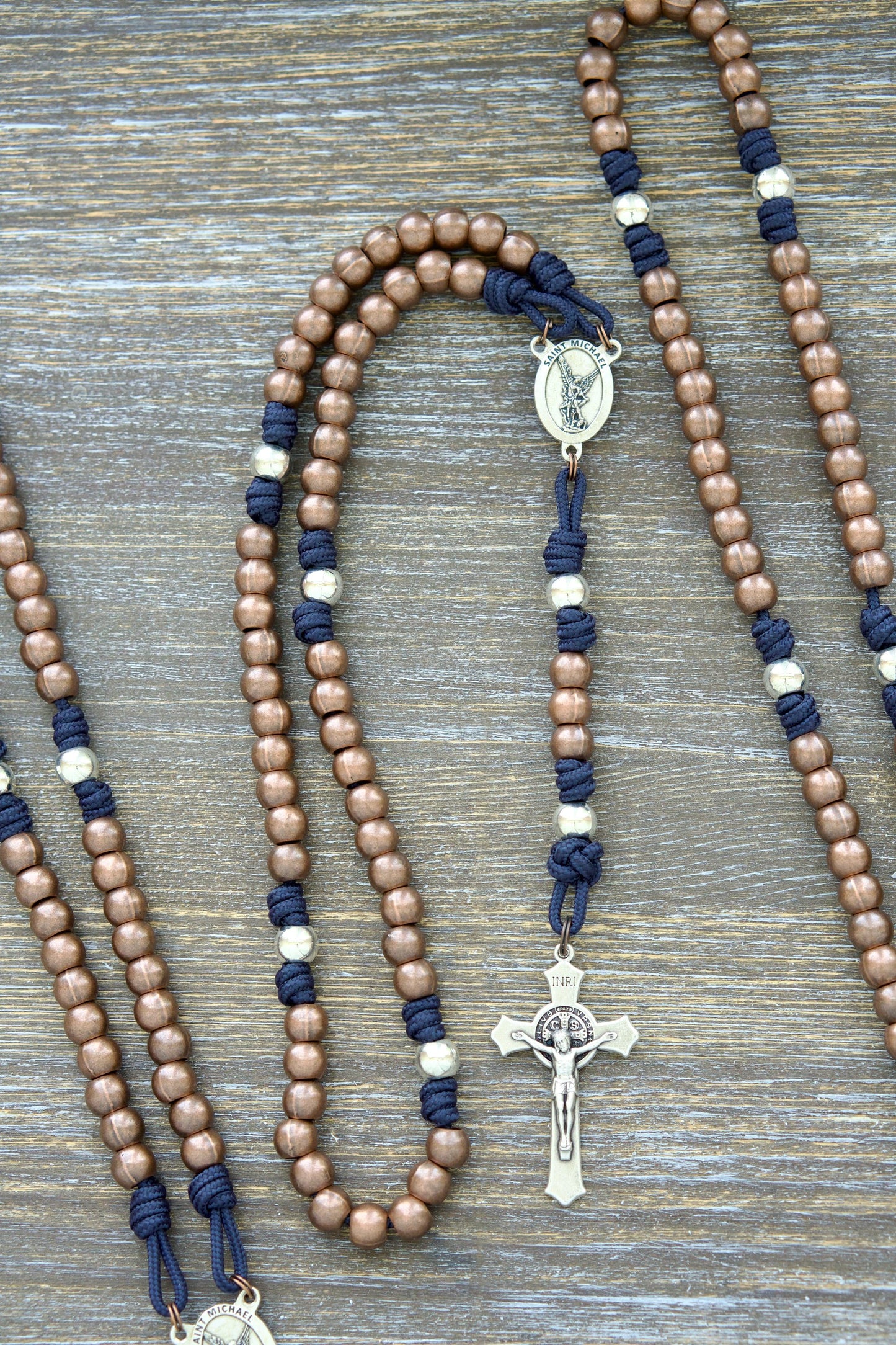 Premium metal paracord rosary, 'St. Michael's Sword,' featuring durable 275 paracord in grey, black, green, or navy blue. Alloy metal Hail Mary (copper) and Our Father (silver) beads.