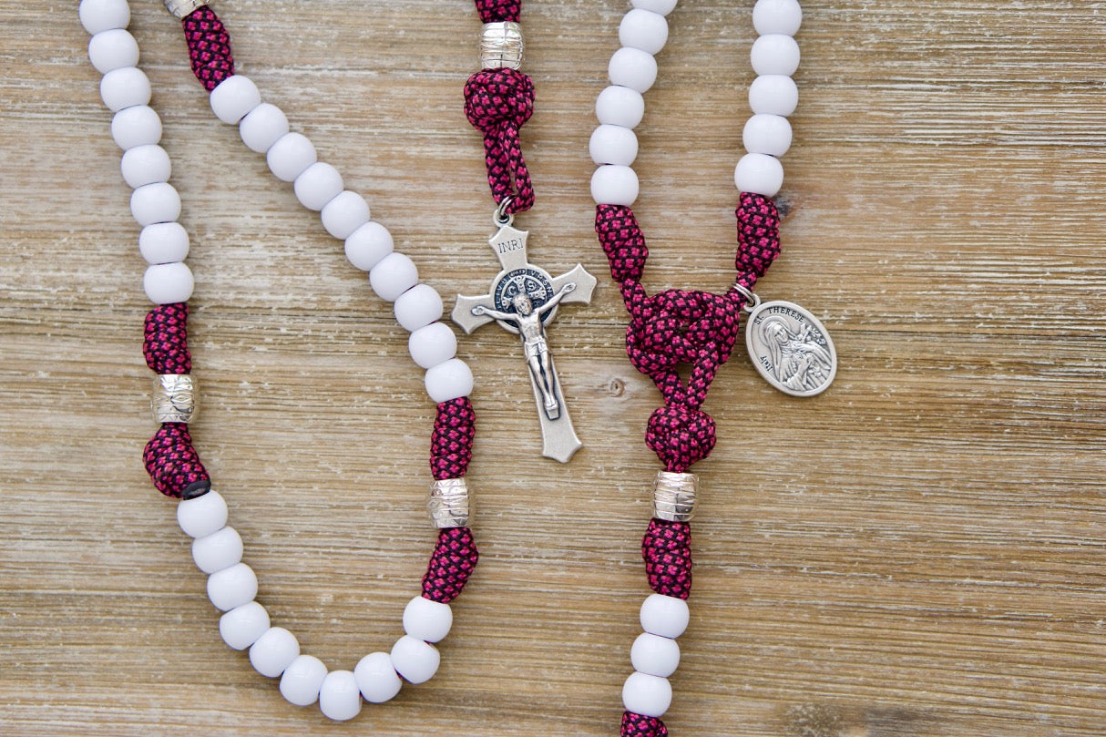 The Little Flower - St. Therese - Rose Pink and White - 5 Decade Paracord Rosary, featuring a durable and unbreakable paracord design with a standard 2" St. Benedict Crucifix and Little Flower devotional medal. Perfect for praying on-the-go or in battle against life's challenges.