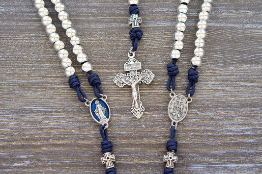 Premium Stella Maris Rosary - Handmade paracord rosary featuring navy blue cord, 10mm silver metal Hail Mary beads, a blue enamel Miraculous Medal centerpiece, and a silver Pardon Crucifix. Inspired by Our Lady, Star of the Sea.