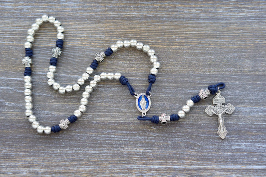 Stella Maris Rosary: Navy blue paracord with shiny silver metal Hail Mary beads, cross Our Father beads, blue enamel Miraculous Medal, and silver Pardon crucifix.