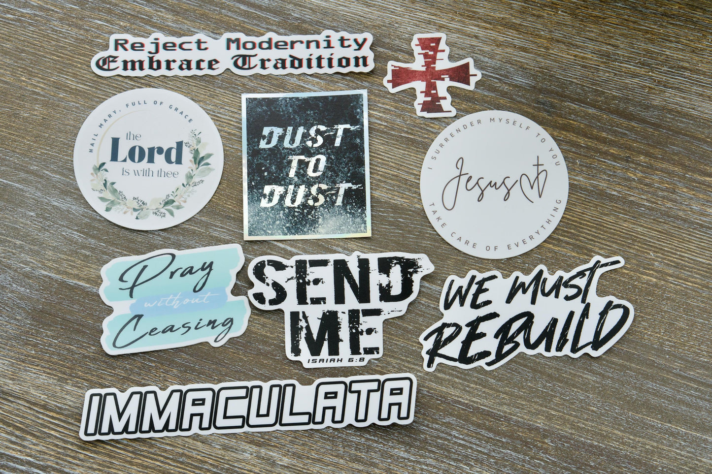 Nine-pack vinyl sticker assortment featuring Catholic imagery and inspirational quotes from Ephesians 6:13. Durable stickers perfect for laptops, water bottles, notebooks, and more, ideal for spreading the faith and invoking St. Maximilian Kolbe's Militia of the Immaculata.