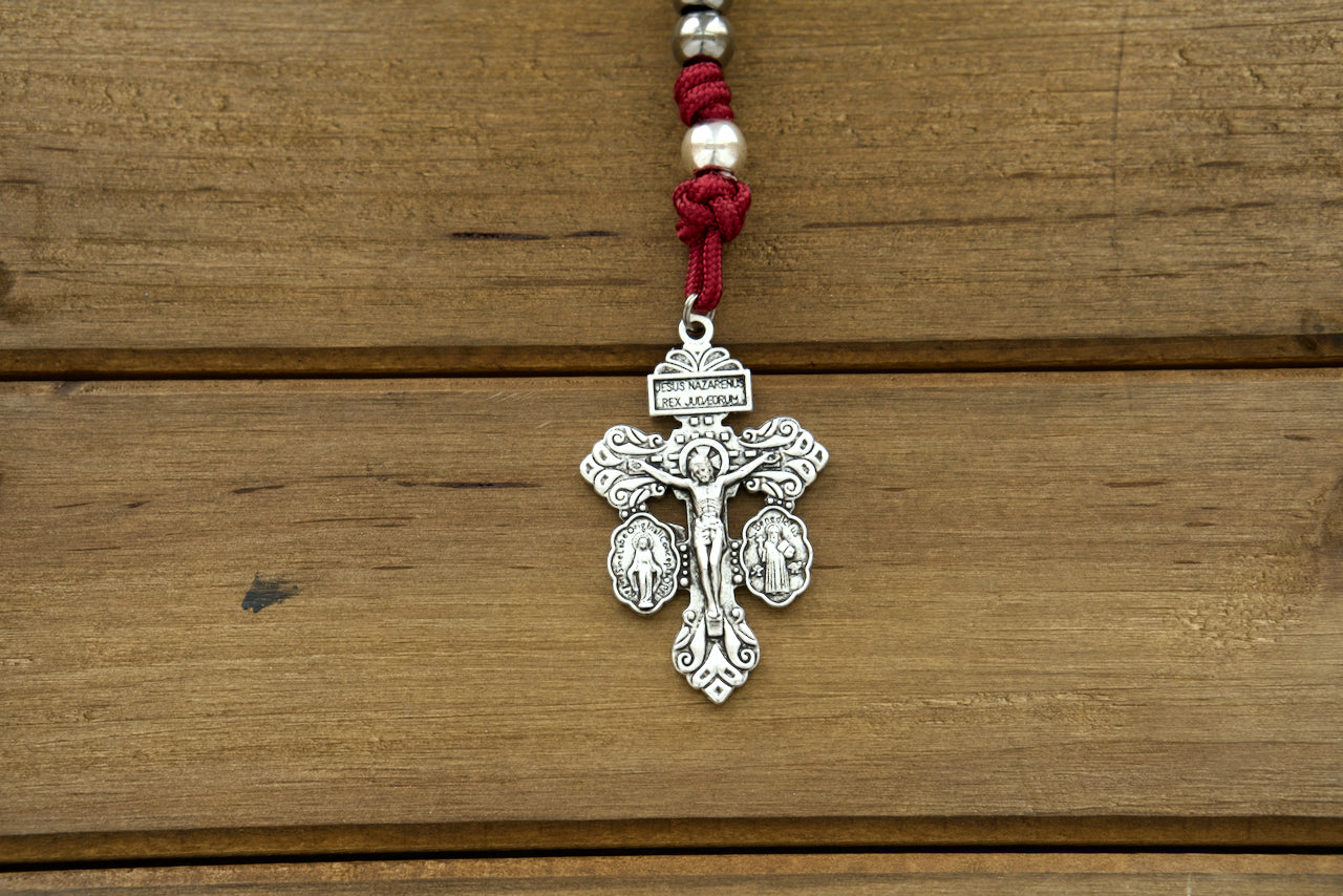 Durable maroon paracord rosary with gunmetal and silver beads, featuring St. Benedict medal centerpiece and standard 2" Pardon Crucifix, perfect for devout Catholics seeking spiritual protection and guidance.