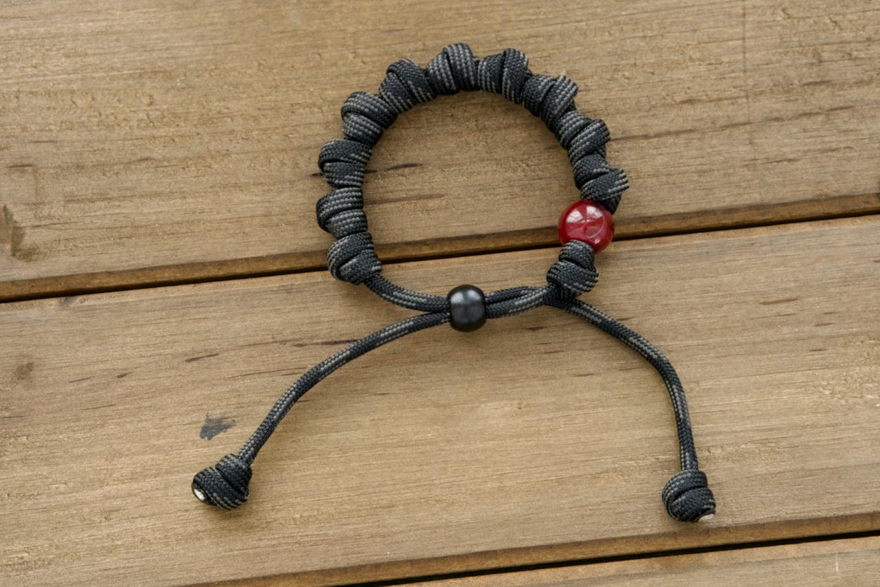 Terror of Demons - Rosary Bracelet, premium black/gray paracord, adjustable design, milky red Our Father bead, spiritual armor, Catholic Faith, unbreakable paracord rosary, gift idea.