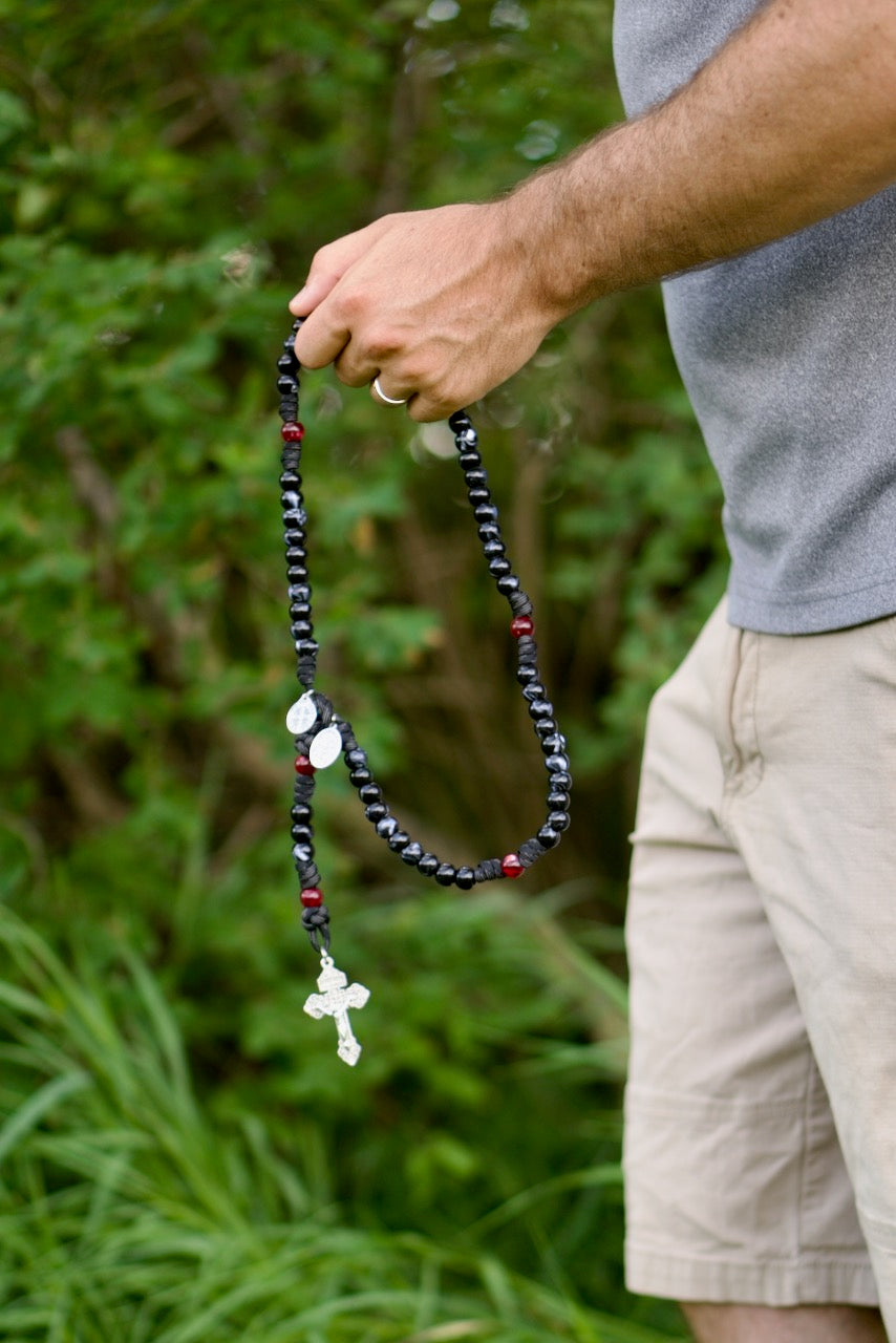 Black and Red Terror of Demons - St. Joseph - 5 Decade Paracord Rosary featuring black/white luster Hail Mary beads, red/maroon Our Father beads, 2-inch silver pardon crucifix, double devotional medals of St. Joseph and St. Benedict, perfect for spiritual protection and on-the-go prayer.