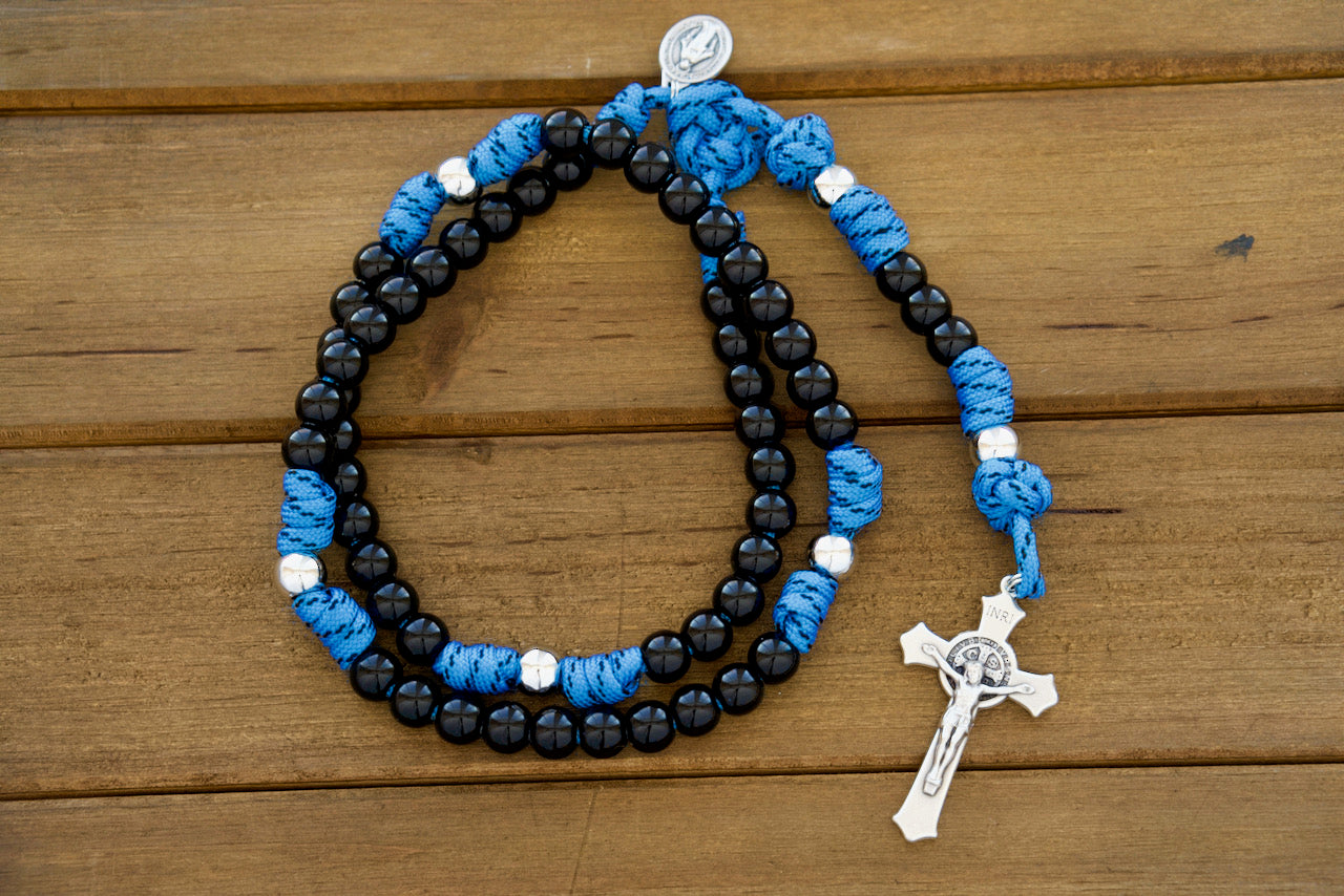 The Royal Warrior | Blue, Black & Silver | 5 Decade Paracord Rosary - Unbreakable Catholic rosary designed for kids with royal blue paracord, black acrylic Hail Mary beads, silver Our Father beads, smaller Miraculous Medal, and 2" St. Benedict Crucifix.