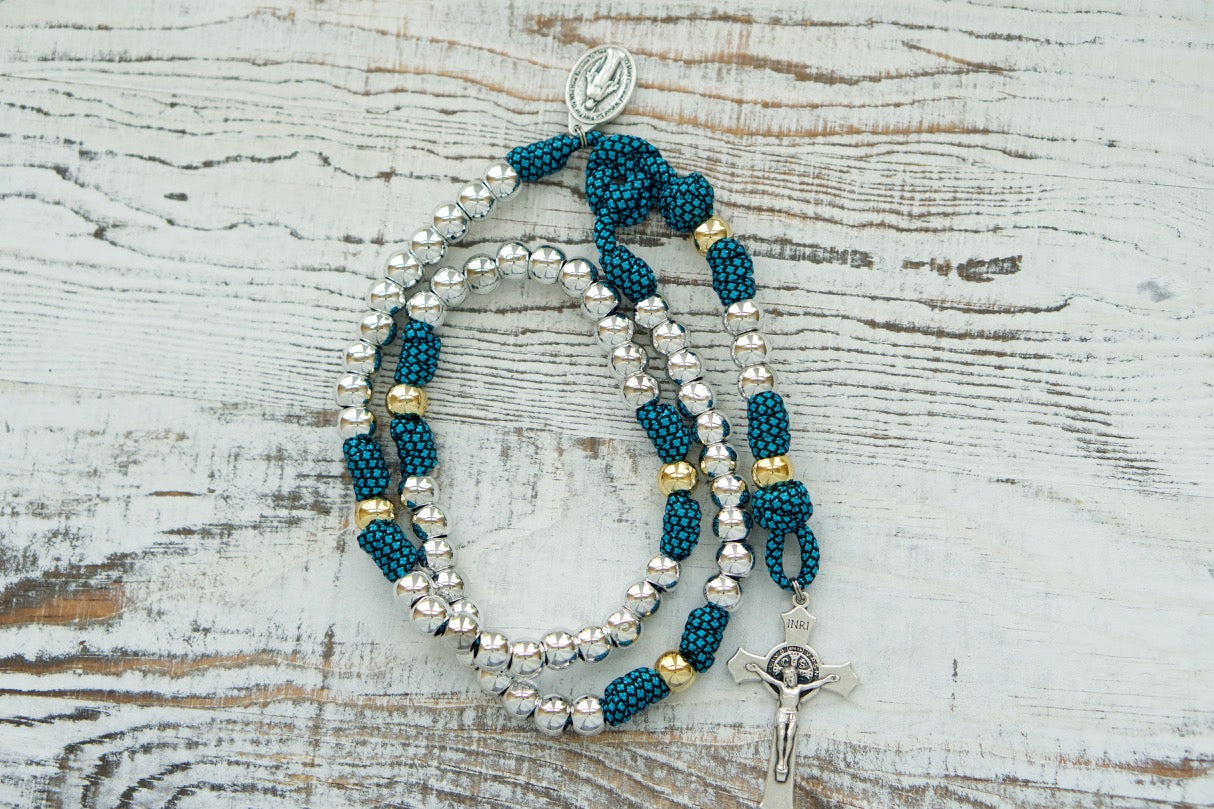 Embrace the Unbreakable Bond with this Turquoise and Silver 5 Decade Paracord Rosary, perfect for any battle-ready Catholic warrior. Handmade by our devout family and rigorously tested for durability, this rosary is a premium, unbreakable weapon for your spiritual journey. Shop now at SanctusServo.com!