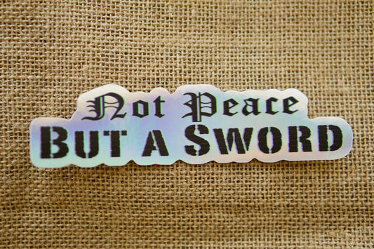 Holographic "Not Peace but a Sword" vinyl sticker, 6" x 1.5", perfect for laptops and other items. Great reminder of Matthew 10:34. Pairs well with Sanctus Servo rosaries for Catholic spiritual warriors.