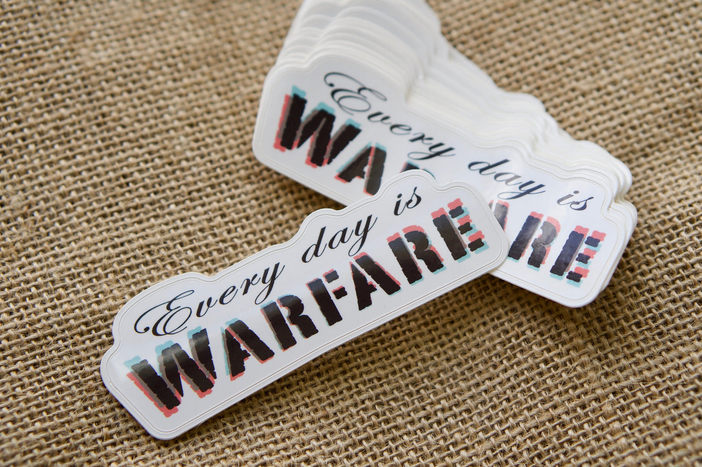 Every day is WARFARE - Vinyl Sticker for Christians, 4" x 1.5", perfect for laptops, water bottles, and notebooks. Spread the message of spiritual warfare and stand firm with God's armor.