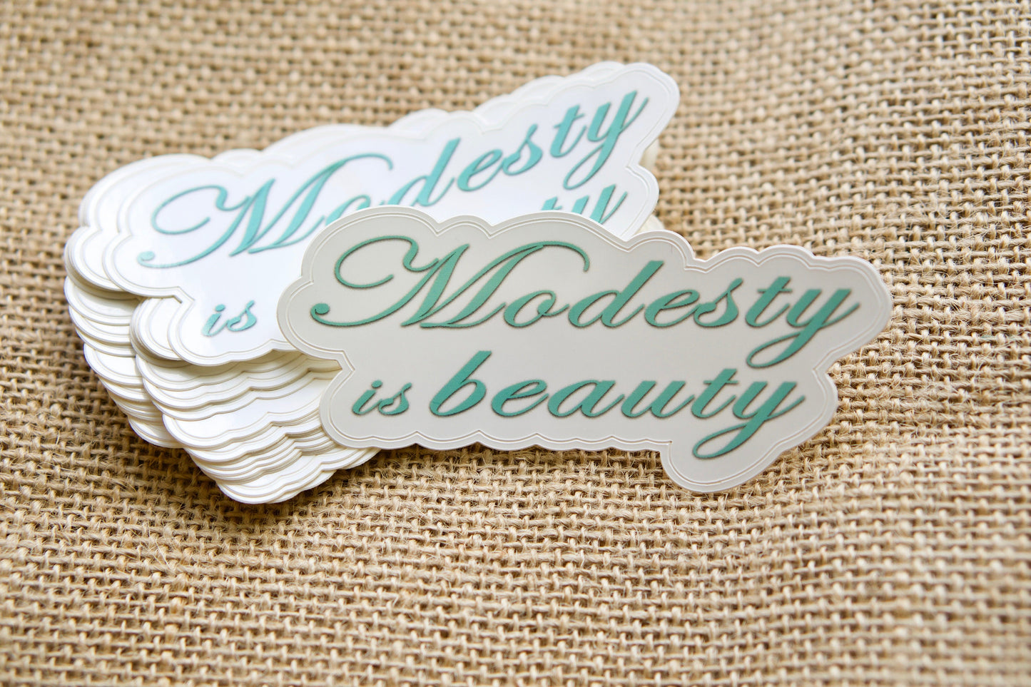4-inch wide x 2-inch tall 'Modesty is Beauty' vinyl sticker, perfect for adorning laptops, water bottles, notebooks or other surfaces to promote the message of inner beauty through modesty. Complements our premium paracord rosaries and makes a thoughtful stocking stuffer.