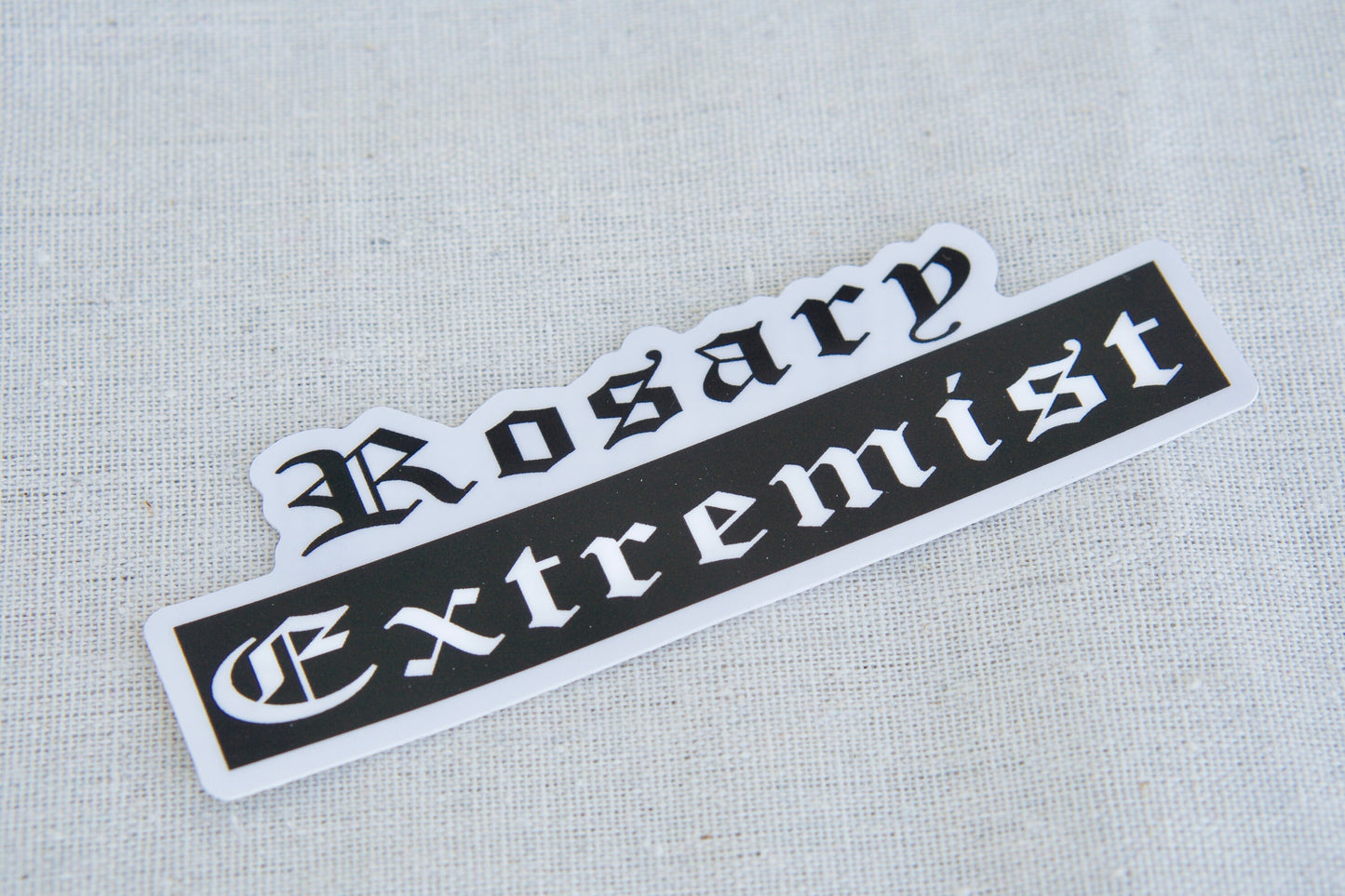 Rosary Extremist Vinyl Sticker - Let the World Know You're a Catholic Warrior! This 4.8" x 1.5" waterproof sticker is made with durable, dishwasher and microwave-safe vinyl, perfect for your laptop, water bottle or notebook. Inspire others to become rosary warriors too!