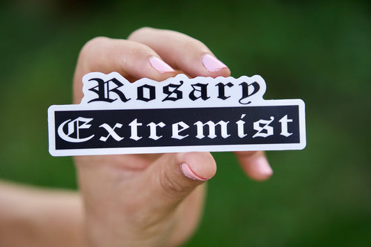 Rosary Extremist Vinyl Sticker - A powerful reminder to be a Catholic extremist, not a lukewarm believer! This 4.8" x 1.5" sticker is perfect for laptops, water bottles, and notebooks, encouraging friends and loved ones to join the ranks of rosary warriors.