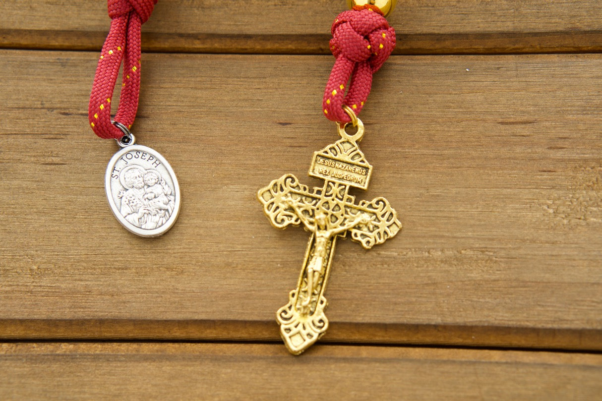 The Holy Family - 1 Decade Paracord Rosary in royal red, gold, and gunmetal design with an antique gold Pardon crucifix and double-sided Holy Family/St. Joseph medal; perfect for kids and adults, durable and unbreakable, handmade by a Catholic family of 6.
