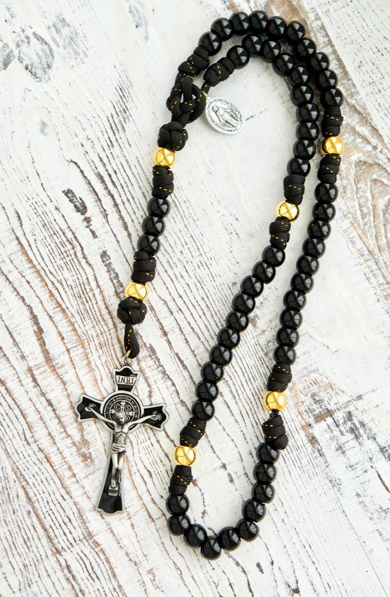 The Holy Servant - Black and Gold - 5 Decade Paracord Rosary: Elegant black paracord with gold ribbon, shiny black Hail Mary beads, lustrous gold Our Father beads, large enamel crucifix, miraculous medal - perfect for prayer practice or a thoughtful gift.
