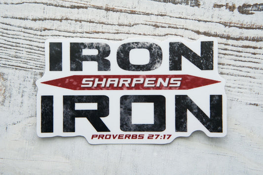 Iron Sharpens Iron (Proverbs 27:17) - Vinyl Sticker - A powerful reminder of our duty to fight together in spiritual warfare. Measuring 4" x 2.25", this durable, waterproof decal is perfect for pairing with a Sanctus Servo rosary.