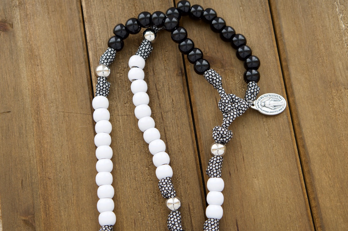 Two handmade 5 decade paracord rosaries in black and white, with St. Benedict crucifixes and Miraculous Medals, perfect wedding gift for Catholic couples.
