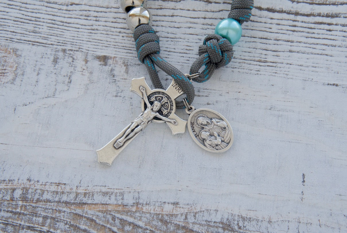 Beautiful gray and blue St. Anne's Intercession 1 Decade Paracord Rosary with silver Hail Mary beads, sky blue Our Father beads, and a devotional medal. Handcrafted by a small Catholic family for powerful spiritual warfare and lasting durability.
