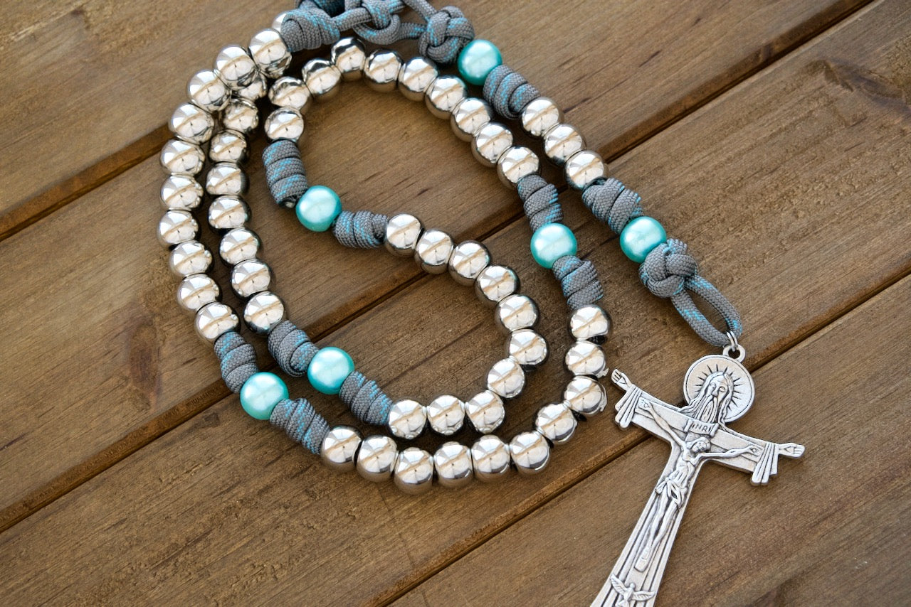 Never walk onto the spiritual battlefield unprepared! Elevate your prayers and strengthen your faith with our sturdy, handmade 5 decade paracord rosaries.