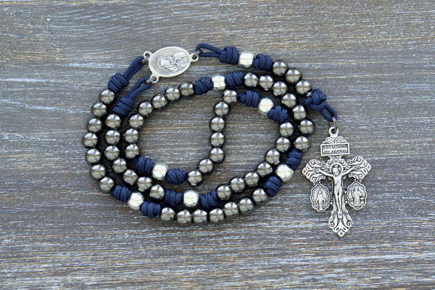 7 Sorrows Servite Rosary with gunmetal beads, navy paracord, Mater Dolorosa centerpiece, and 2" Triple Threat Pardon crucifix.