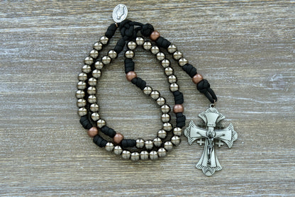 Ancient Armor - 5 Decade Paracord Rosary: Unbreakable, premium quality rosary for Catholic warriors. Featuring large gunmetal Hail Mary beads, antique copper Our Father beads, black paracord, a grey Jerusalem cross, and Miraculous Medal devotional medal. 