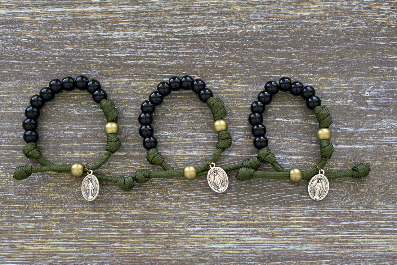 Kid's Army Green and Black Rosary Bracelet with 10mm black beads, olive Our Father bead, and a small Miraculous Medal on paracord rope - perfect for active Catholics.