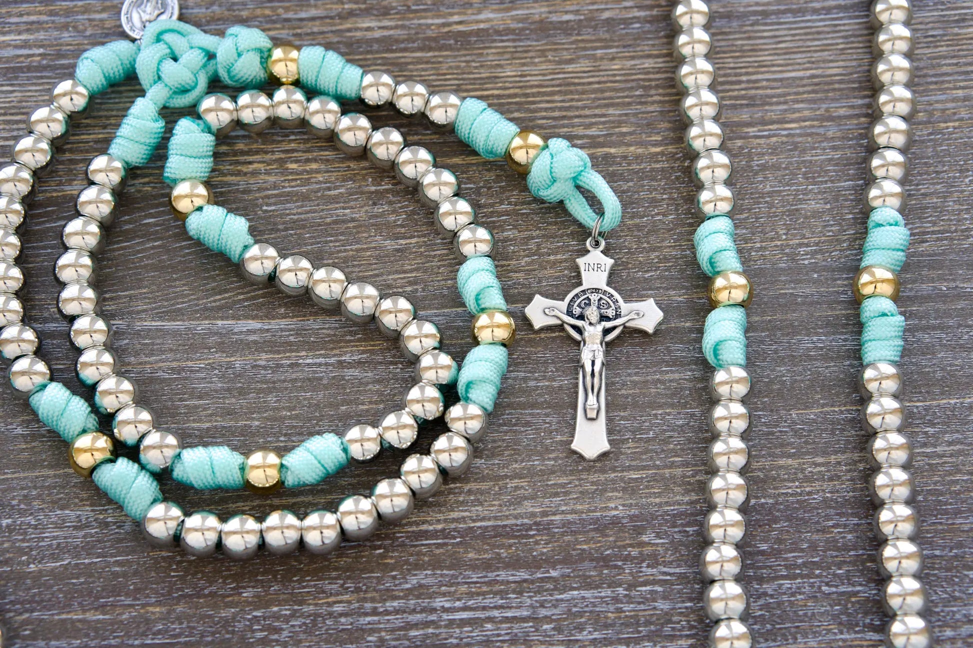 Sturdy paracord rosary for girls, teal blue with silver/gold 10mm beads, ideal for prayer and spiritual strength.