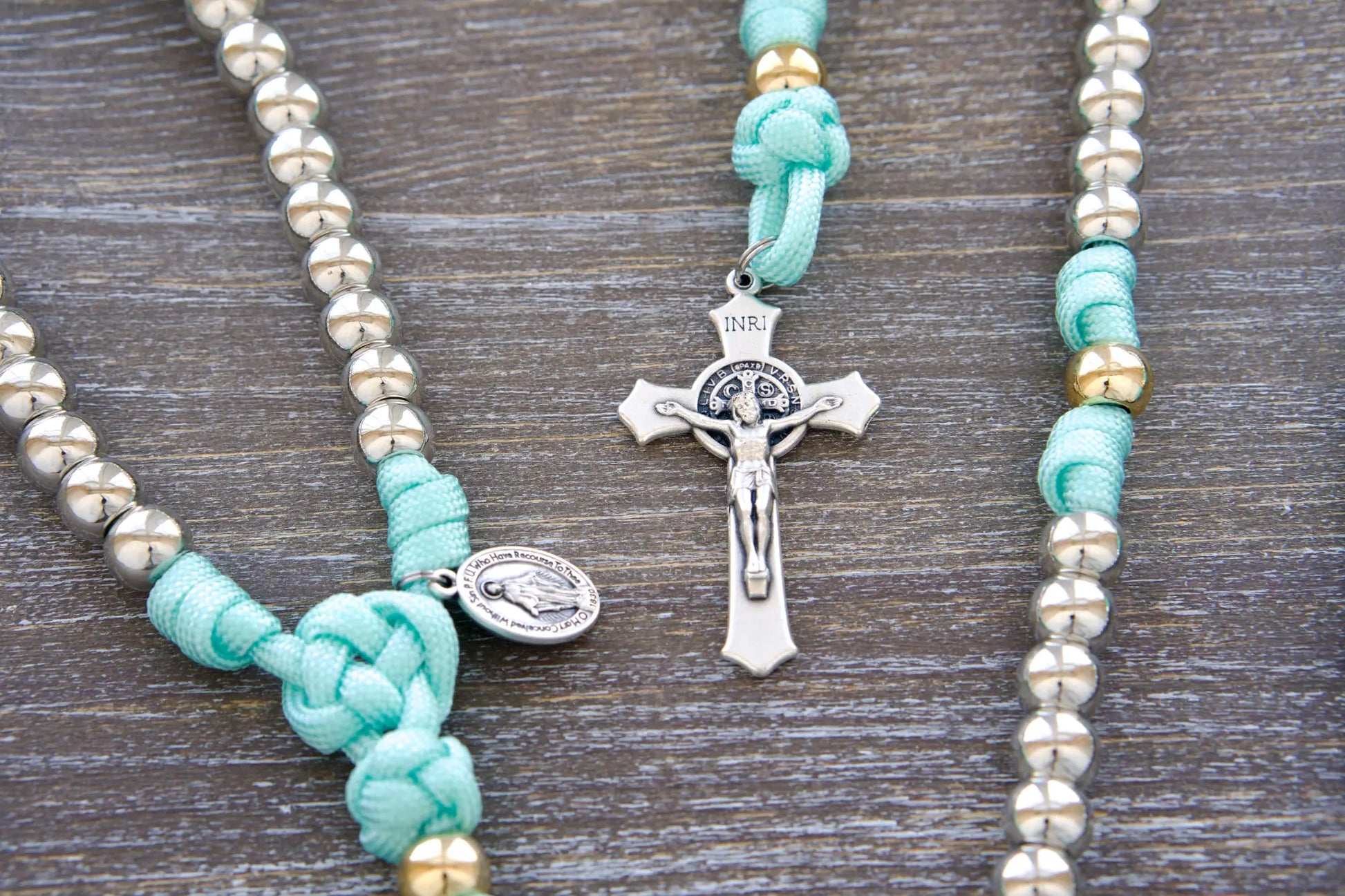 Unique 5-decade paracord rosary: teal blue rope, silver/gold 10mm beads, perfect for young women's spiritual journey.