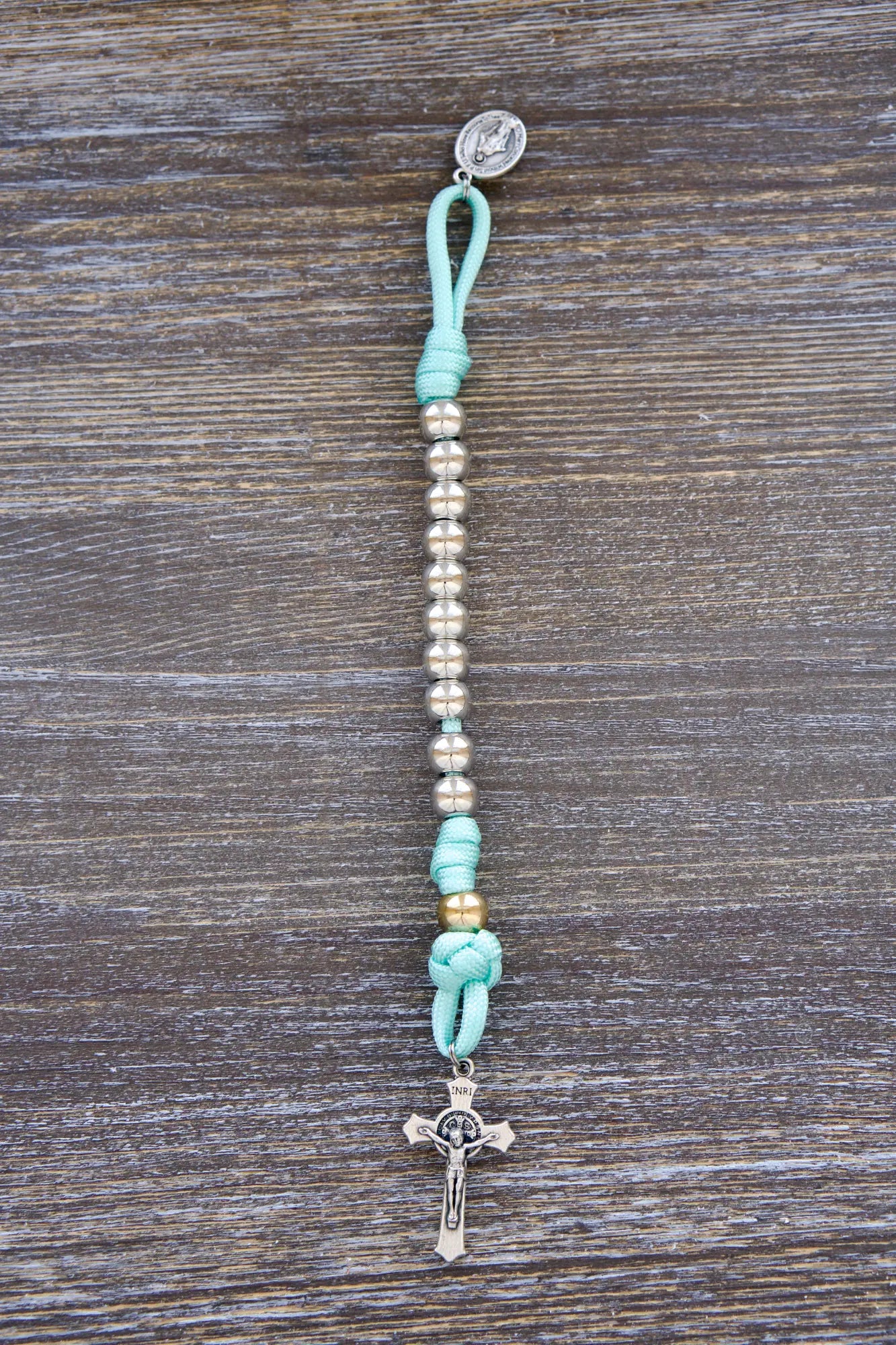 August Queen of the Heavens Kids Paracord Rosary with teal cord, royal silver beads, 2" St. Benedict crucifix, and 3/4 inch Miraculous Medal