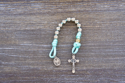 August Queen of the Heavens kids' paracord rosary with teal cord, royal silver and gold beads, 2" St. Benedict crucifix, and 3/4 inch Miraculous Medal
