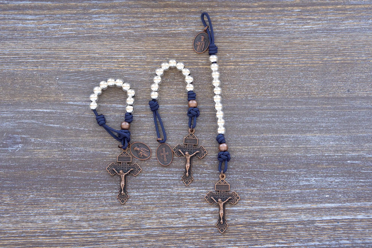 Benedict’s Battle Rosary: pocket size paracord rosary made with metal beads, navy blue rope and copper accents.