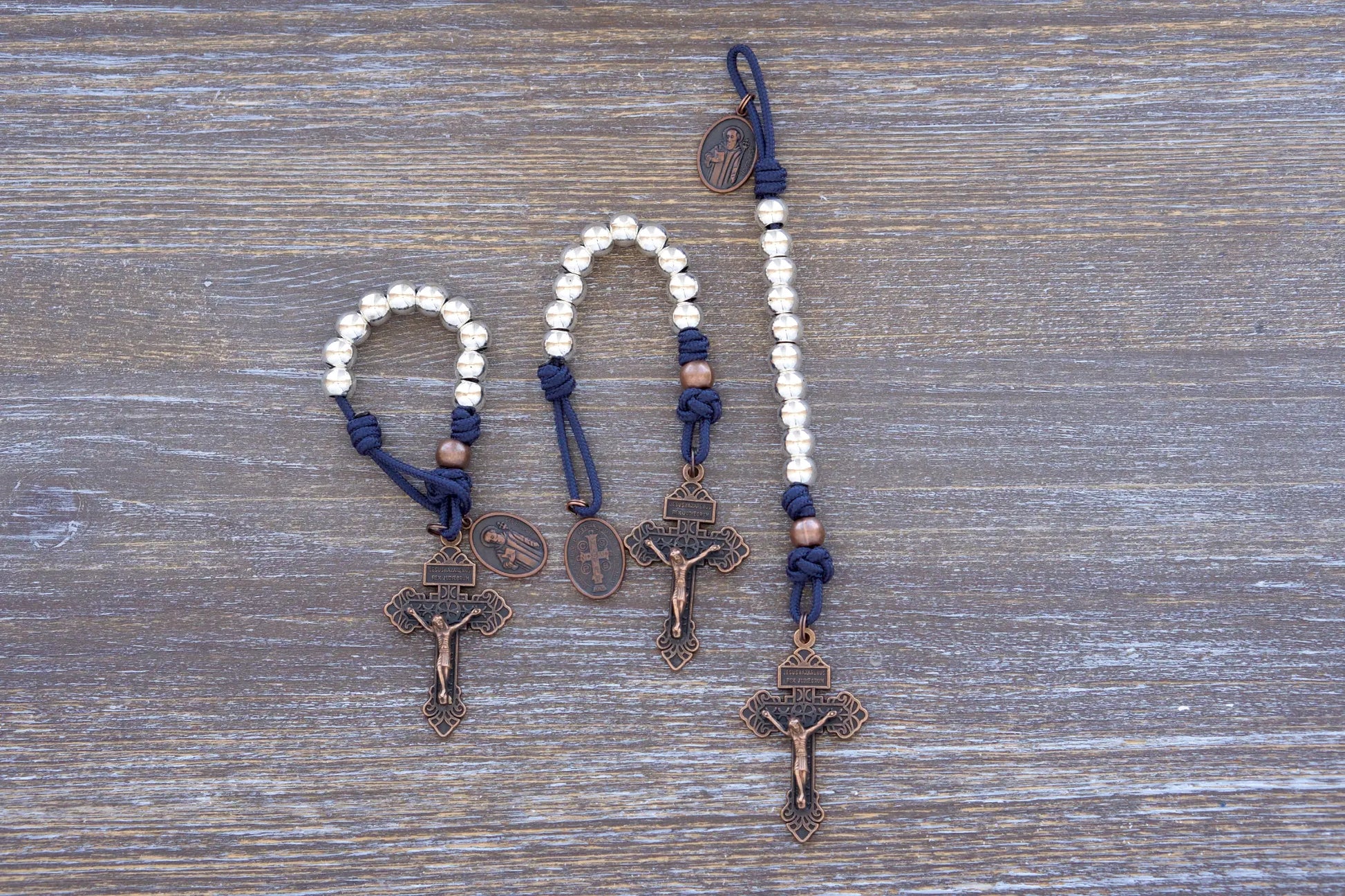 Benedict’s Battle Rosary: pocket size paracord rosary made with metal beads, navy blue rope and copper accents.