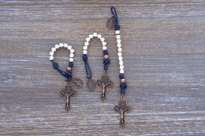 Benedict’s Battle Rosary: pocket size paracord rosary made with metal beads, navy blue rope and copper accents.