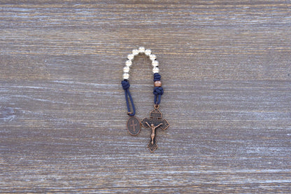 Benedict’s Battle Rosary: compact metal paracord rosary with navy rope, copper accents, and durable, premium finish.