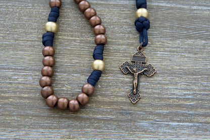 Blessed Be God - 5 Decade Paracord Rosary: Premium quality, unbreakable paracord rosary with antique copper and matte gold beads, navy blue accent rope, Miraculous Medal, and 2-inch copper Pardon Crucifix.