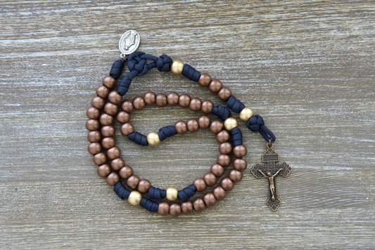 Blessed Be God - 5 Decade Paracord Rosary, Premium Quality Unbreakable Catholic Gift with Navy Blue Rope, Antique Copper Hail Mary Beads, and Matte Gold Our Father Beads. Handmade by Sanctus Servo's Small Catholic Family.