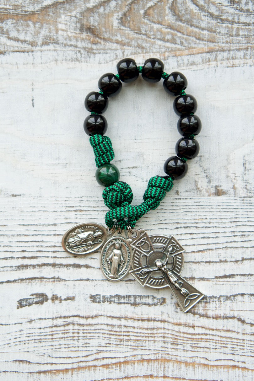 Beautifully crafted paracord rosary featuring green and black beads, an Irish Trinity crucifix, and a Miraculous Medal. Perfect for honoring the faith of St. Patrick and St. Bridget while adding a touch of Irish heritage to your prayer practice.