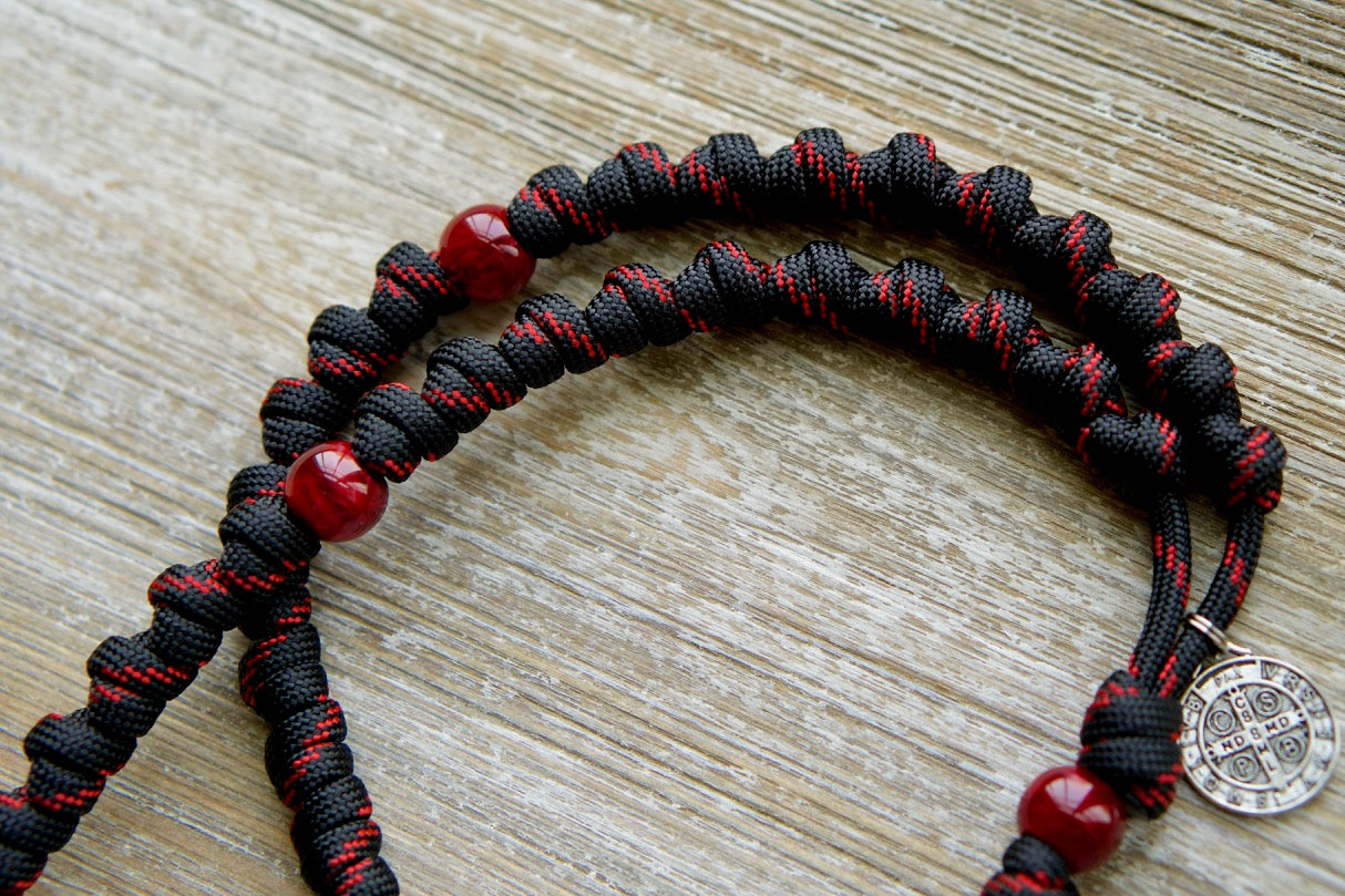 The Blood of Christ - Red and Black Knotted Rope Rosary: A powerful, durable paracord rosary symbolizing the Passion with bold red Our Father beads and intricately knotted Hail Mary beads. Crafted by our devout Catholic family for daily devotion or as a meaningful gift.