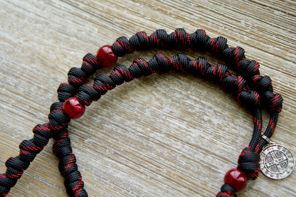The Blood of Christ - Red and Black Knotted Rope Rosary: A powerful, durable paracord rosary symbolizing the Passion with bold red Our Father beads and intricately knotted Hail Mary beads. Crafted by our devout Catholic family for daily devotion or as a meaningful gift.