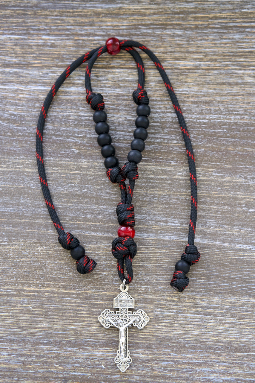 Blood of Christ - Rearview Mirror Rosary, a stylish paracord mirror rosary featuring a 9-inch adjustable length with black and red accents, matte acrylic Hail Mary beads.