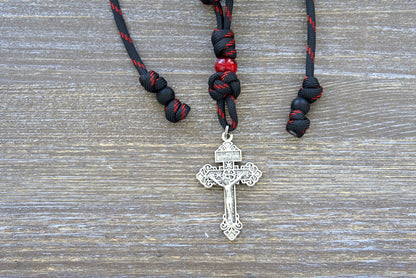 Blood of Christ - Rearview Mirror Rosary: A striking 9-inch paracord rosary featuring matte black Hail Mary beads, a captivating silver Pardon Crucifix, and a red Our Father bead.