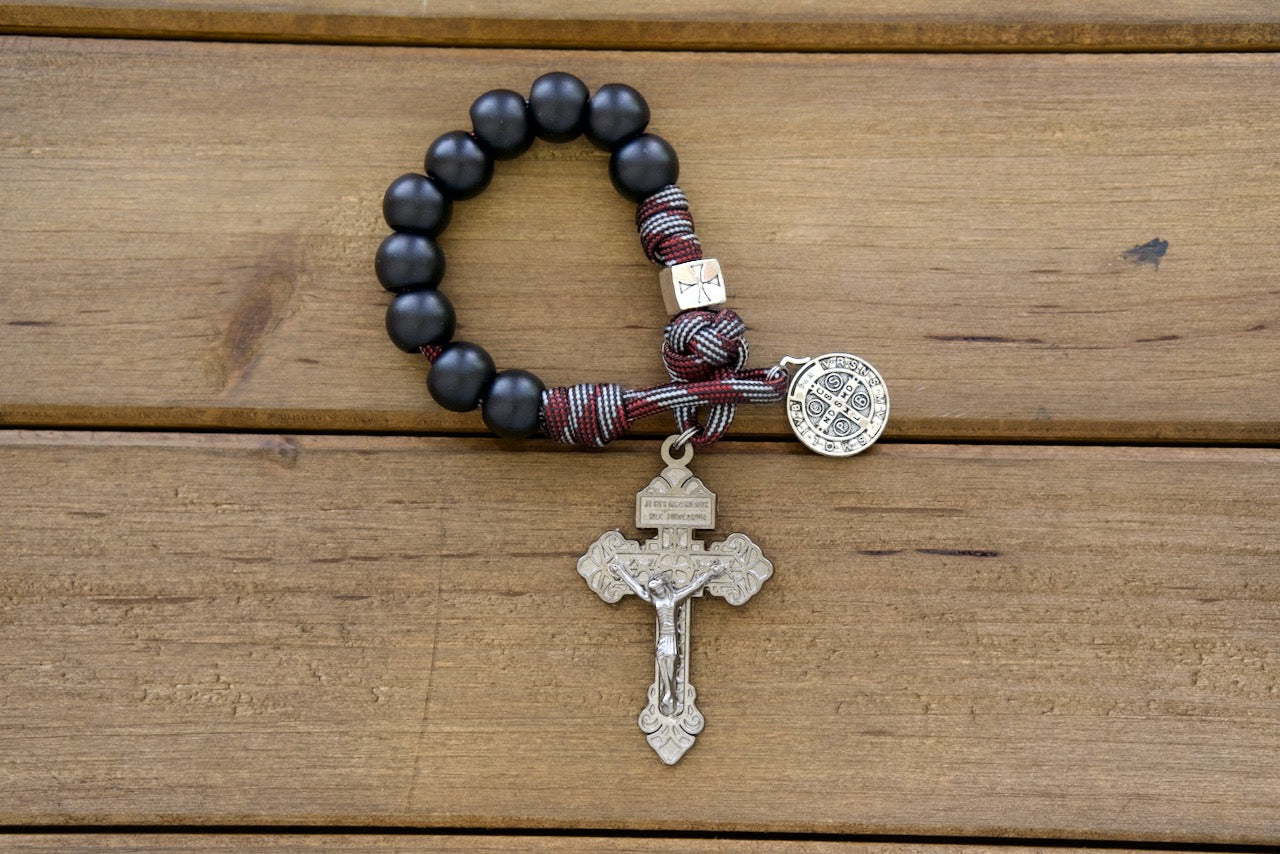 The Crusader - DEUS VULT! - A pocket-sized, unbreakable paracord rosary crafted with premium materials for ultimate durability and spiritual strength. Empower your faith journey with this red and silver 1 Decade Paracord Rosary featuring matte black acrylic Hail Mary beads and a metal alloy crusader Our Father bead.