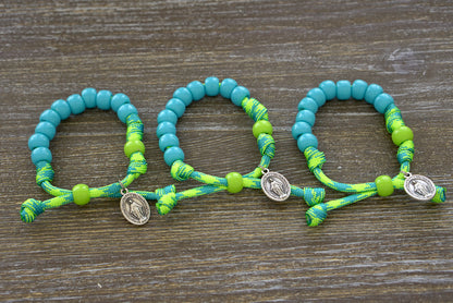 David's Slingshot - Kid's Rosary Bracelet, vibrant lime green and sky blue paracord with blue Hail Mary beads and lime green Our Father bead, petite Miraculous Medal, perfect for young Catholics.