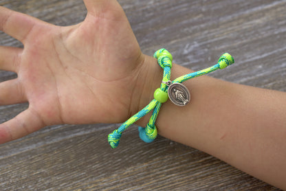 David's Slingshot Kids Rosary Bracelet - A vibrant and stylish Catholic accessory featuring lime green and sky blue paracord, blue Hail Mary beads, a matching Our Father bead, and a petite Miraculous Medal.