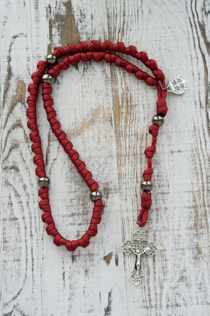 Embrace strength and faith with our new Maroon & Gunmetal Knotted Rope Rosary - The Defender of Faith, featuring durable paracord construction and premium Gunmetal beads for unbreakable Catholic worship on or off the battlefield.