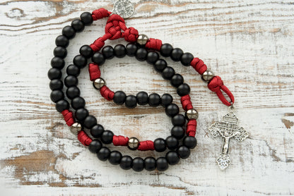 Maroon and Black 5 Decade Premium Paracord Rosary, an unbreakable Catholic gift for those who want to stand strong in their faith and defend it with style! With durable materials and a powerful design, this rosary is perfect for spiritual warriors.