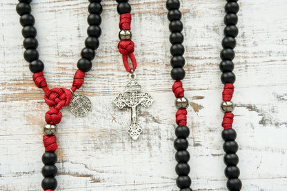The Defender of Faith - Maroon and Black - 5 Decade Paracord Rosary: A bold and unbreakable paracord rosary for Catholics, featuring gunmetal Our Father beads and a silver St. Benedict devotional medal, perfect for your spiritual journey and an ideal Catholic gift.