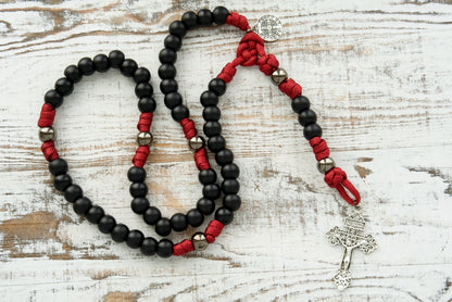 Embrace the power of The Defender of Faith - Maroon and Black 5 Decade Paracord Rosary! Stand unwavering in your faith with this premium, durable Catholic gift featuring bold color combination and gunmetal Our Father beads.